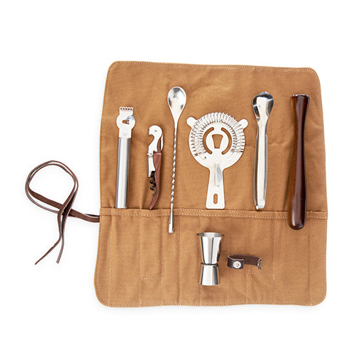 a jigger, strainer, wood-wrapped truetap, channel knife/zester, bar spoon, ice tongs, and wood muddler in a canvas roll up holder